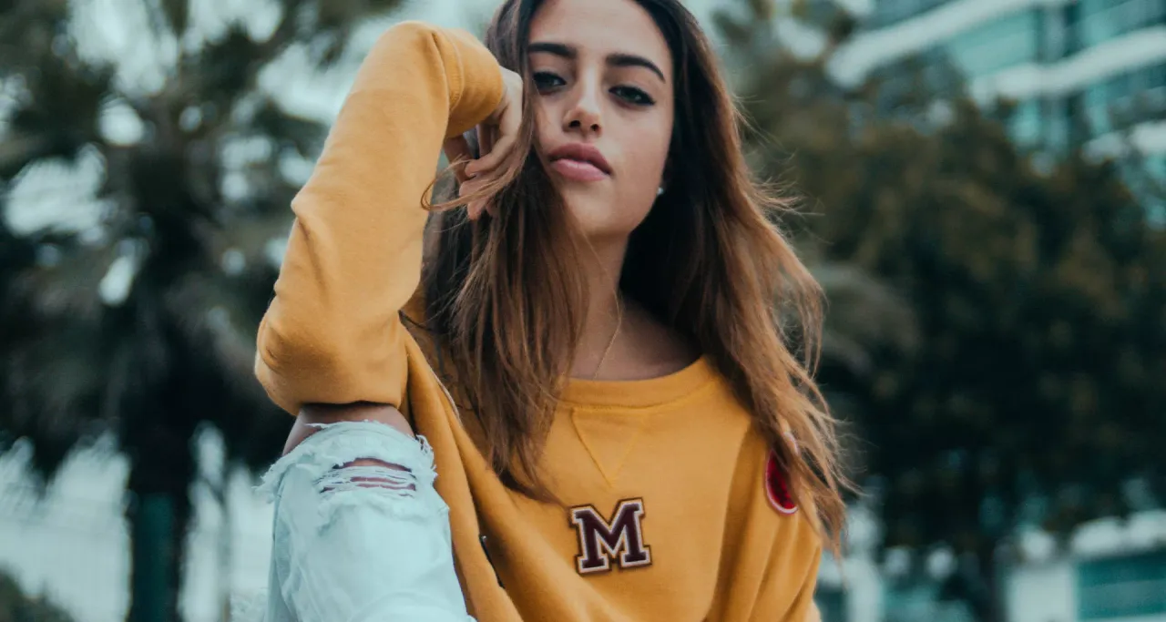 Young woman in a yellow jumper
